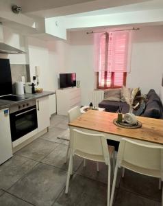 a kitchen and living room with a table and chairs at Cozy haven in Venise Provençale in Martigues