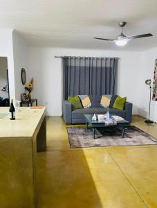 a living room with a couch and a table at Bushbuck Rest in Marloth Park