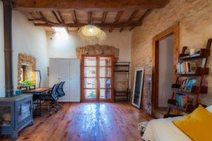 a bedroom with a bed and a desk and a table at Can Vicent Corda in Sant Francesc Xavier