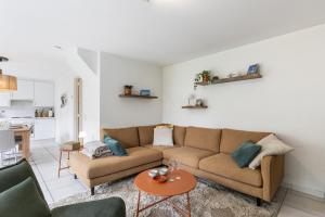 a living room with a couch and a table at Sea Side Village 91 in De Haan