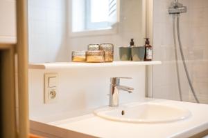 a bathroom with a sink and a mirror at Sea Side Village 91 in De Haan +7 photos