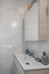 a white kitchen with a sink and a counter at Can Vicent Corda in Sant Francesc Xavier +22 photos