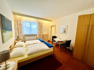a hotel room with a bed and a table at Berghof Werfenweng in Werfenweng