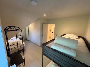 a bedroom with two bunk beds in a room at Villa Médard in Bruges