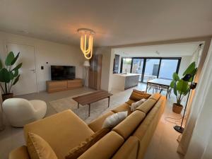 a living room with a couch and a table at Villa Médard in Bruges