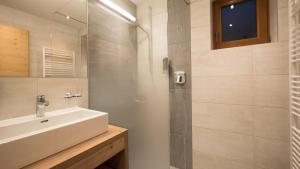 a bathroom with a sink and a shower at Hotel & Apart Central in Fügen +97 photos