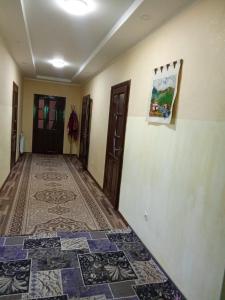 a hallway with a tile floor in a house at Rest Hous Adis in Kyzart