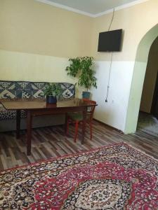 a living room with a couch and a table at Rest Hous Adis in Kyzart
