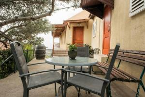 a table and chairs and a bench on a patio at la noach in Metulla