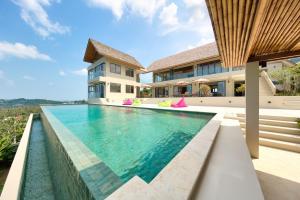 an infinity pool in the backyard of a house at Nojoom Hills - Sea View 6 Bedroom Villa in Bophut