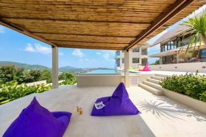 a house with purple pillows on a patio at Nojoom Hills - Sea View 6 Bedroom Villa in Bophut 