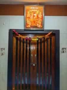 a sign above a wooden door in a building at RAM DARBAR PALACe & APS HOTEL in Umariā
