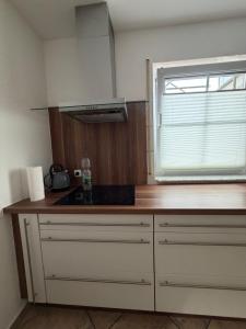 a kitchen with a counter top and a window at Ferienwohnung Olpe in Olpe