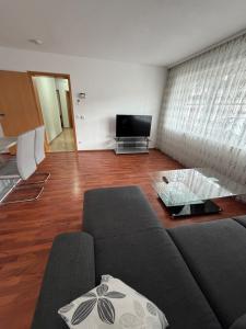 a living room with a couch and a tv at Ferienwohnung Olpe in Olpe