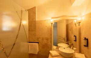 a bathroom with a sink and a toilet and a shower at L'Oustau des Palunettes Concept Adulte only in Saintes-Maries-de-la-Mer +35 photos