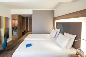 a hotel room with a bed and a desk at Novotel Moscow City in Moscow