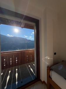 a room with a window with a view of a mountain at Alpine Living Apartments in Bormio