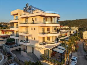 an apartment building with a sign on it at Hotel Olserd in Ksamil