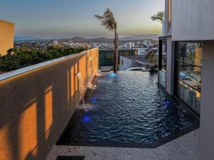 a swimming pool on the side of a building at Hotel Olserd in Ksamil