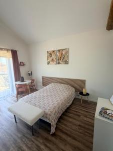 a bedroom with a bed and a table at Escapade Beaujolaise - Studio in Taponas