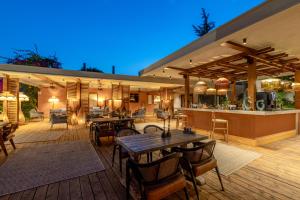 an outdoor patio with tables and a bar at Beach 222 Oludeniz in Oludeniz