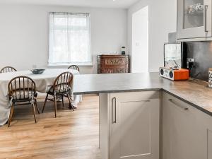 a kitchen with a table and a dining room at The Anchorage in Collieston