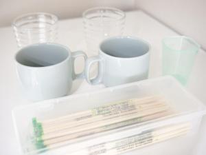 two cups and some chopsticks on a white table at リバーレインアクア in Kagoshima