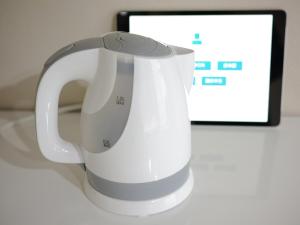 a white jug sitting on a table next to a tablet at リバーレインアクア in Kagoshima