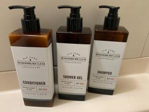 a group of three shampoo bottles sitting on a shelf at リバーレインアクア in Kagoshima