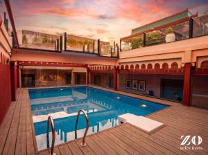a large swimming pool in a building with a ceiling at Zo Selections Jaipur by Zostel in Jaipur +49 photos