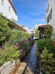 a garden with flowers next to a building at Miji Stay in Fethiye