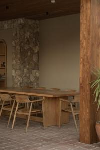 a wooden table in a room with a stone wall at Asfiya Sea View Hotel in Kalkan