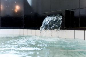 a water fountain in a pool of water at VillaMer KAWACHI in Kumamoto
