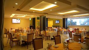 a dining room with tables and chairs in a restaurant at Amdina Hotel in Mekʼelē +44 photos