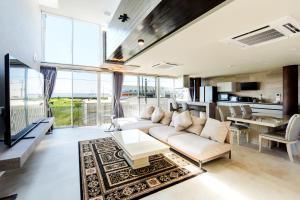 a living room with a couch and a table at VillaMer KAWACHI in Kumamoto