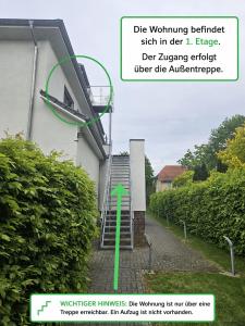 a building with a green arrow on the side of it at Weserblick Apartment Stolzenau 24h Selfcheckin in Stolzenau