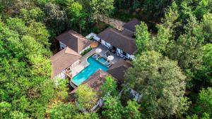 an overhead view of a house with a swimming pool at The Leela Coorg Forest Sanctuary in Madikeri
