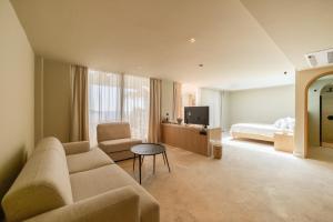 a living room with a couch and a bed at Asfiya Sea View Hotel in Kalkan