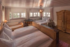 a bedroom with two beds and a living room with a couch at Ansitz Wartenfels in Thalgau +45 photos