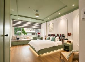 a bedroom with a large bed and a window at Elm Riverside Hotel by Urban B in Ho Chi Minh City