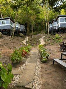 a row of camping cottages in the woods at Chalok Garden bungalow in Ko Tao +14 photos