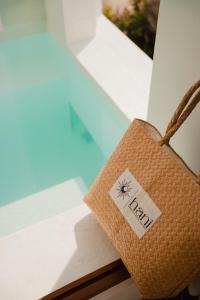 a rattan bag with the word reril on it sitting in a window at Hani Boutique Hotel Phú Quý in Cù Lao Thu