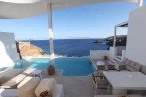 a villa with a pool and a view of the ocean at Three Drops in Kanala