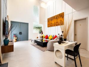 a living room with a couch and a table at YUSETH Private Villa in Phumi Ta Phul