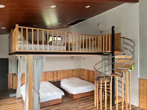 a bunk bed and a staircase in a room at 自在居森林民宿 in Wufeng