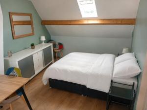 a bedroom with a bed and a table and a desk at Cote d'opale Terre & Mer in Outreau