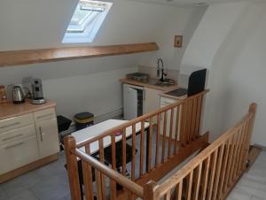 a kitchen with a staircase with a laptop computer on it at Cote d'opale Terre & Mer in Outreau