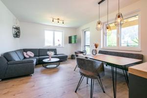 a living room with a couch and a table at Appartement Bergblick Eben in Eben im Pongau