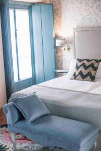 Un pat sau paturi într-o cameră la Casa Boutique La Pila del Pato