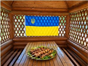 a plate of food in a wooden room with a flag at Хостел в Карпатах in Yasinya